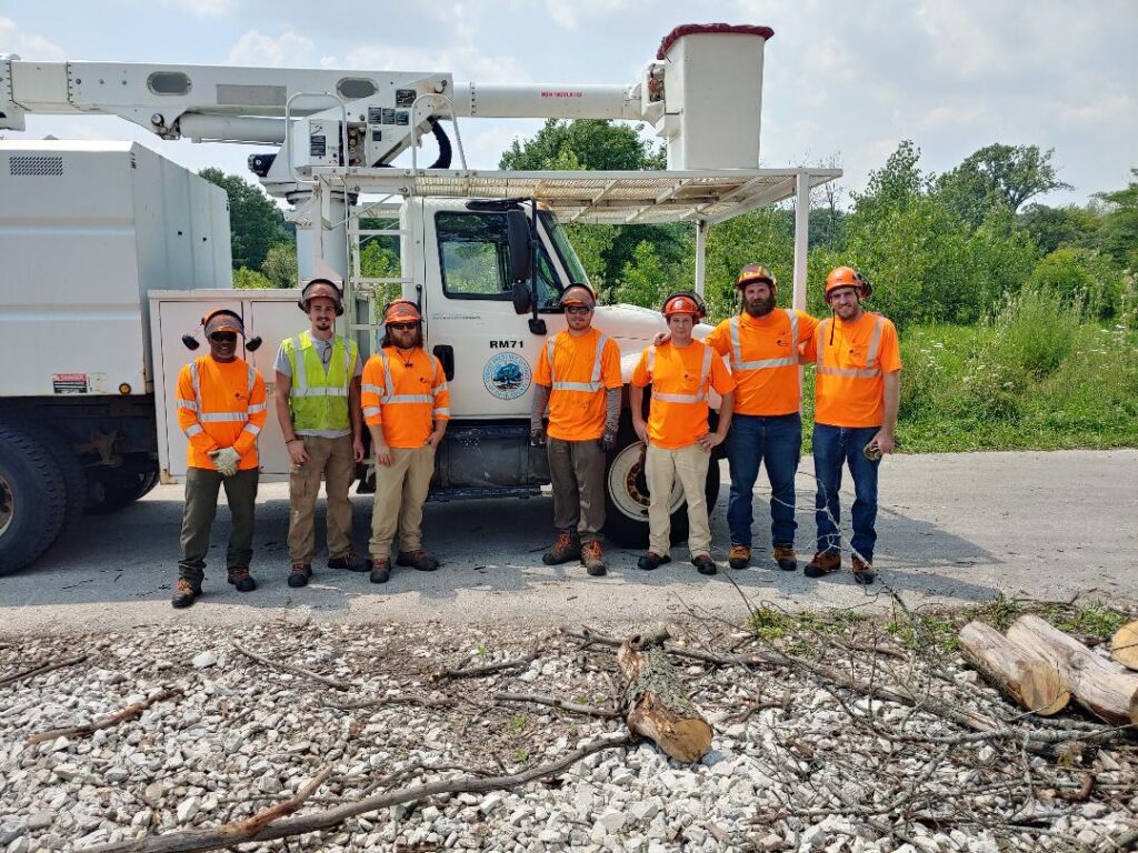 A group of arborists in front of a lift