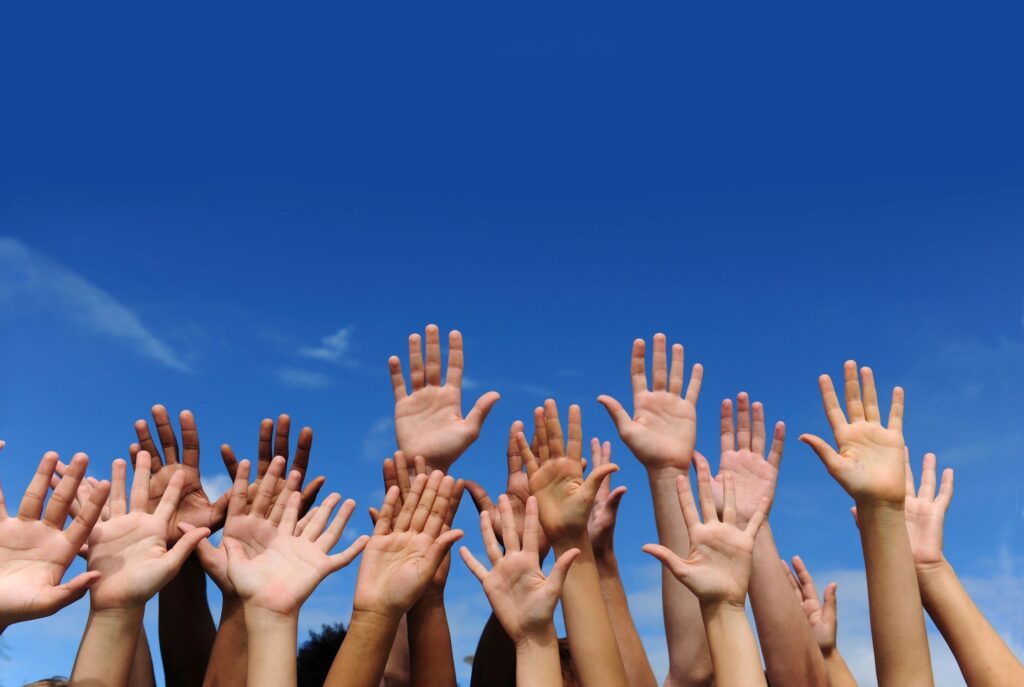 Group Of People Raising Both Their Hands